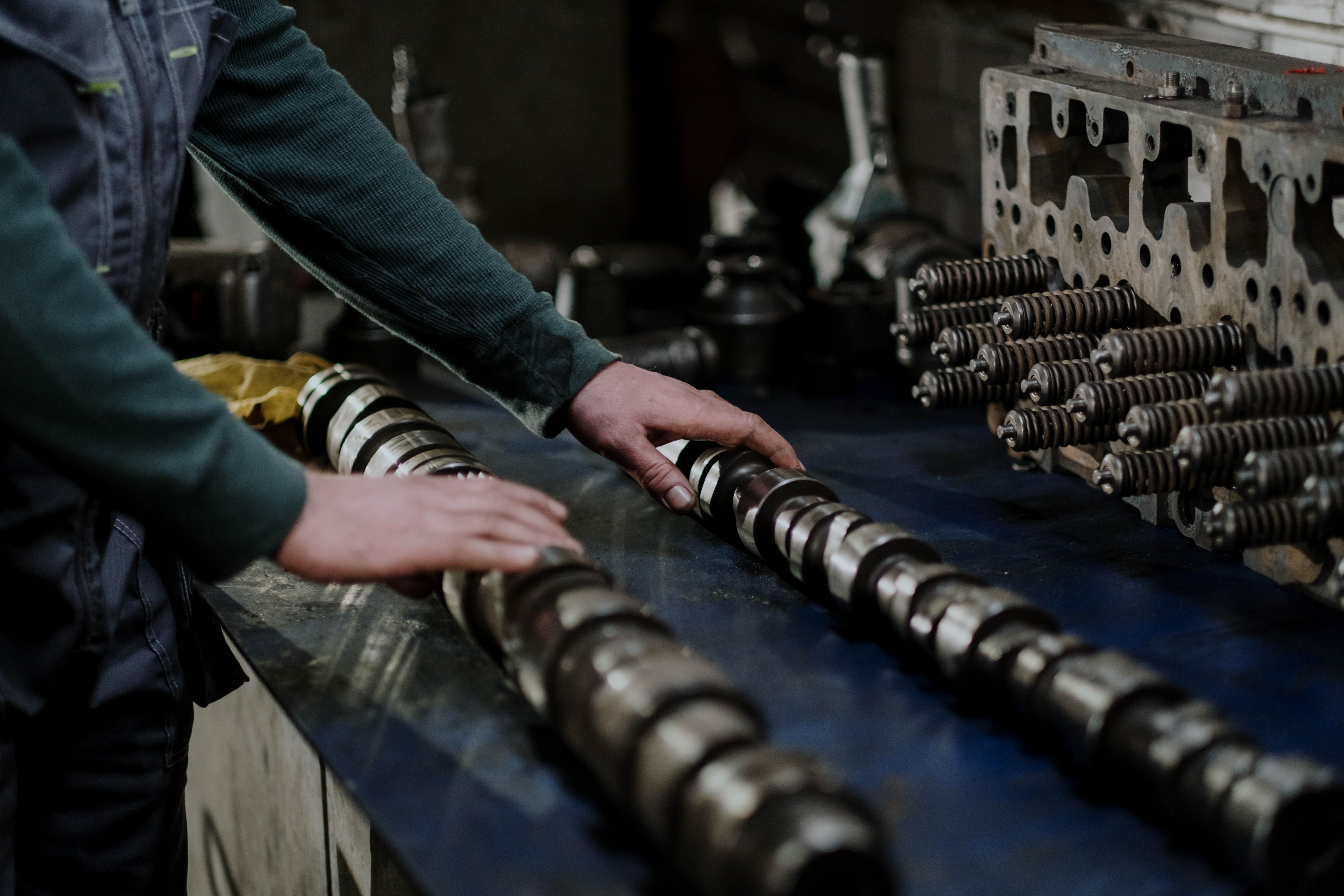 Camshafts and cylinder head components laid out in an automotive workshop